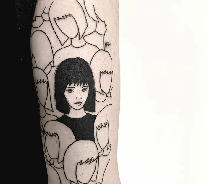 Mental health tattoo of a woman with a black bob haircut, surrounded by faceless figures, symbolizing individuality and mindfulness.