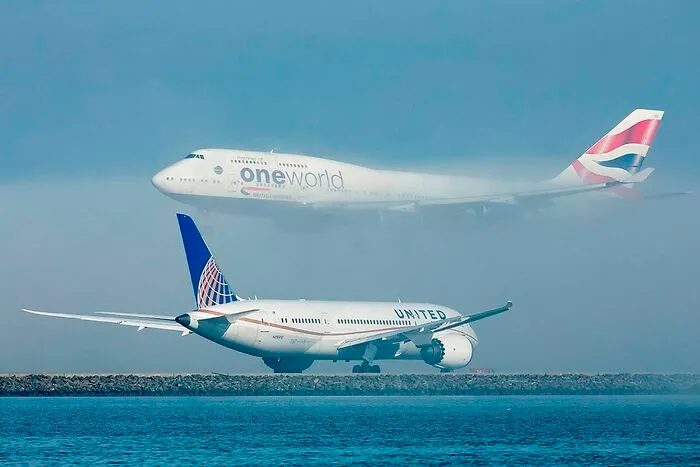 A United Airlines Boeing Dreamliner Holds Position At San Francisco As A British Airways Boeing Beautifully Descends Through The Fog To Land