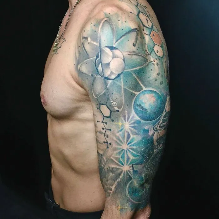 Arm with science-themed tattoo featuring atoms, molecules, and planets.