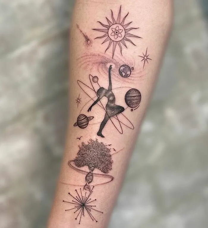 Science tattoo featuring planets, DNA, a dancer, and cosmic elements on an arm, symbolizing exploration and discovery.