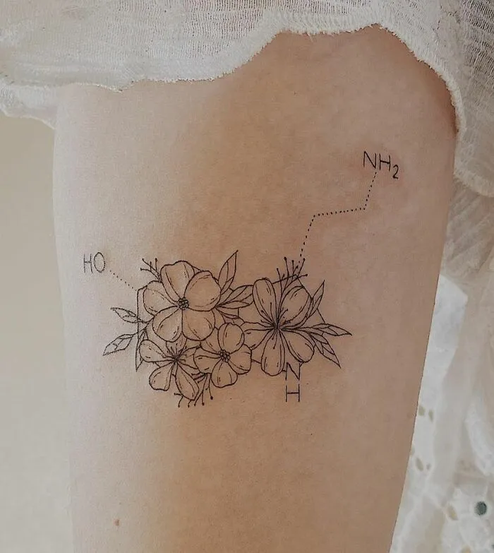 Science tattoo featuring flowers with chemical structure elements on skin.