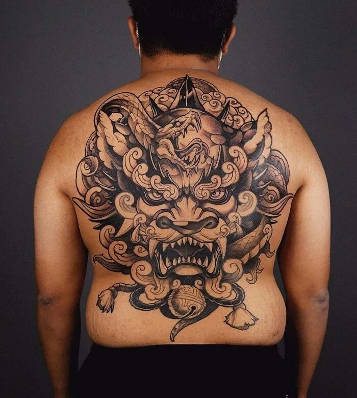 Back with an intricate snake tattoo design, showcasing a detailed mythical creature motif.