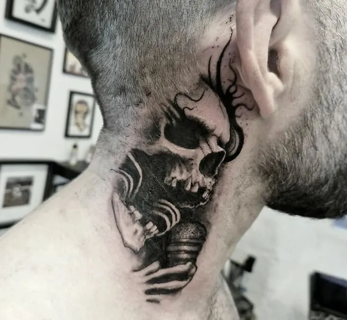 Neck tattoo featuring a detailed Gothic skull design.
