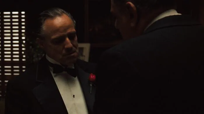 Don Vito Corleone talking with Luca Brasi