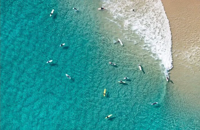 An Aerial Photograph Of Surfers In Byron Bay