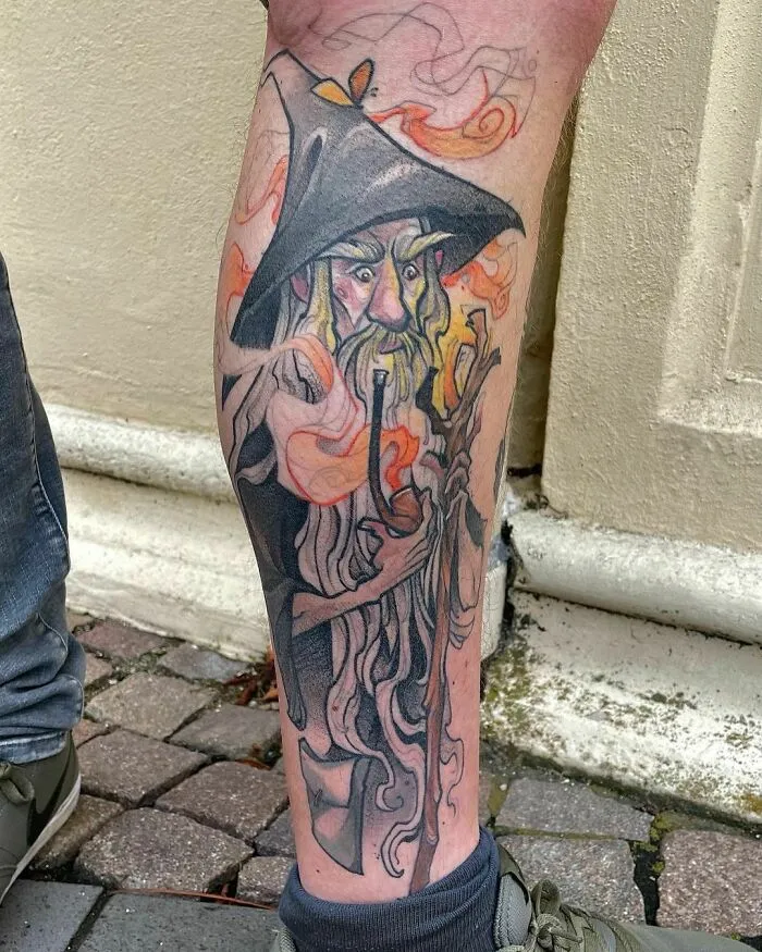Tattoo of a wizard from Lord of the Rings on a person's leg, featuring vibrant colors and intricate details.