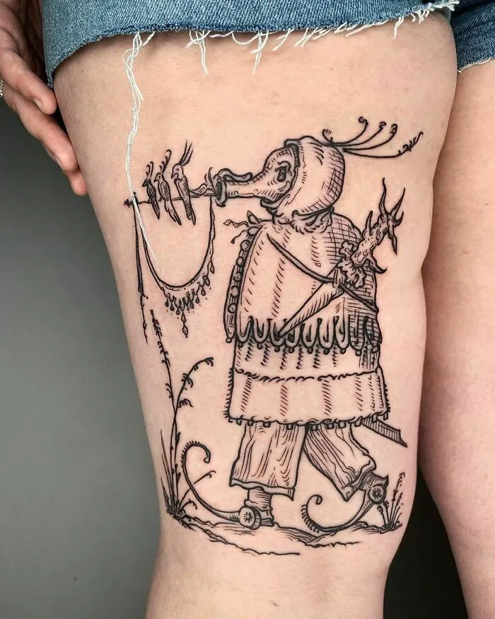 Tattoo of a whimsical, medieval-style figure with a bird's head and intricate details, illustrating gothic tattoo art.