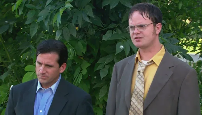 Micheal Scott and Dwight Schrute standing outside while being wet