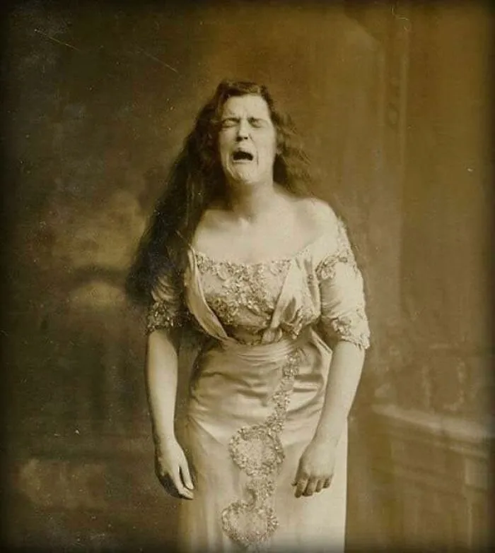 A Portrait Taken Of A Woman While She Was Mid-Sneeze