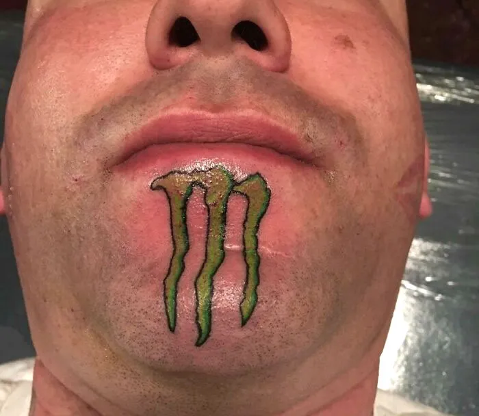 Chin tattoo of a green claw mark, showcasing a permanent mistake in getting inked.