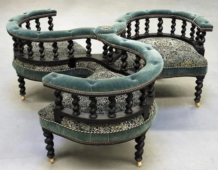Victorian Courting Conversation Chair, Europe 19th Century.  Three Tub Back Chair With Fine Turned Wood Spindles Over Finely Turned Legs Ending In Castor Wheels Upholster In Deep Green And Botanical Velvet