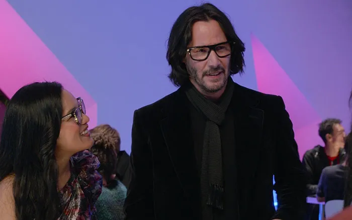 Keanu Reeves wearing jacket and glasses