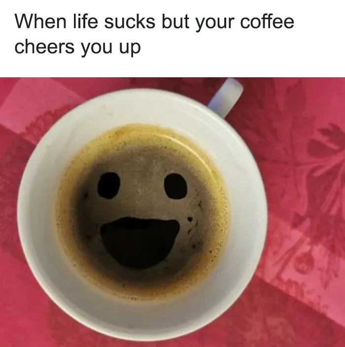 A coffee meme featuring a top-down view of a coffee cup with the foam forming a smiley face. The text above the image reads, "When life sucks but your coffee cheers you up." The meme humorously highlights the comforting and mood-lifting effect of a good cup of coffee, even when things aren't going well.