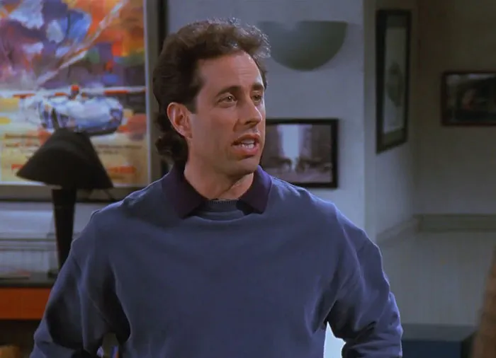 Jerry wearing a blue sweater delivering one of the funniest Seinfeld quotes about everyday life in a classic sitcom scene