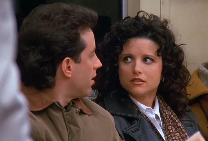 Elaine in black jacket and scarf talking to Jerry in iconic Seinfeld scene illustrating funniest Seinfeld quotes about everyday life