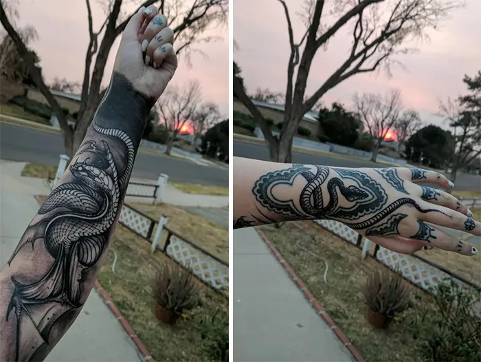 Snake tattoos on an arm and hand, featuring detailed black ink designs in an outdoor setting.