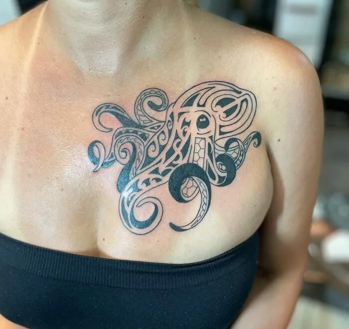 Chest tribal tattoo featuring intricate octopus design.