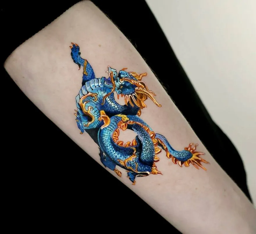 Realistic Blue And Golden Colored Dragon Tattoo