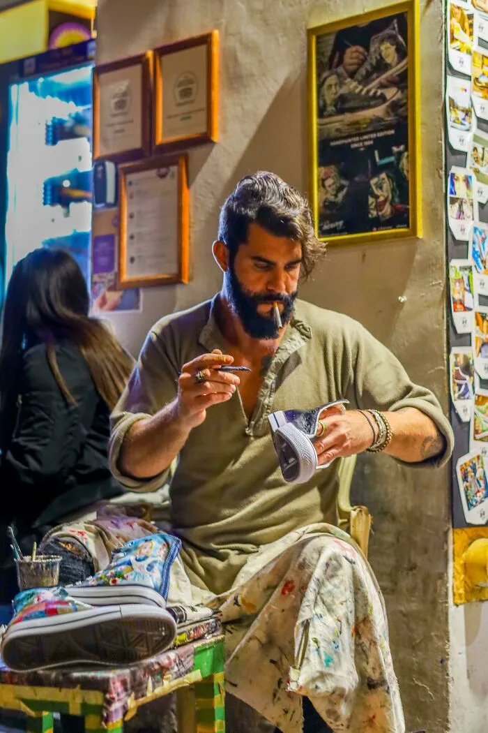 ITAP Of A Man Painting Shoes On A Rome Street