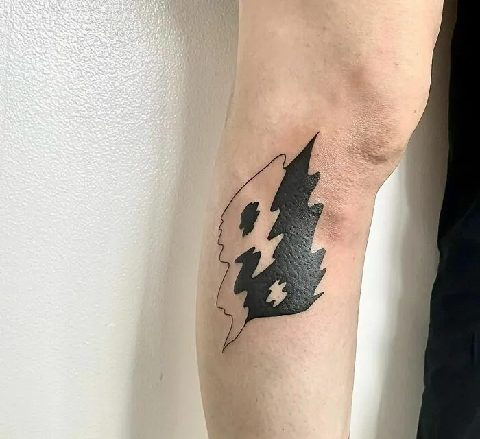 Abstract yin yang tattoo design on inner forearm, embracing duality.