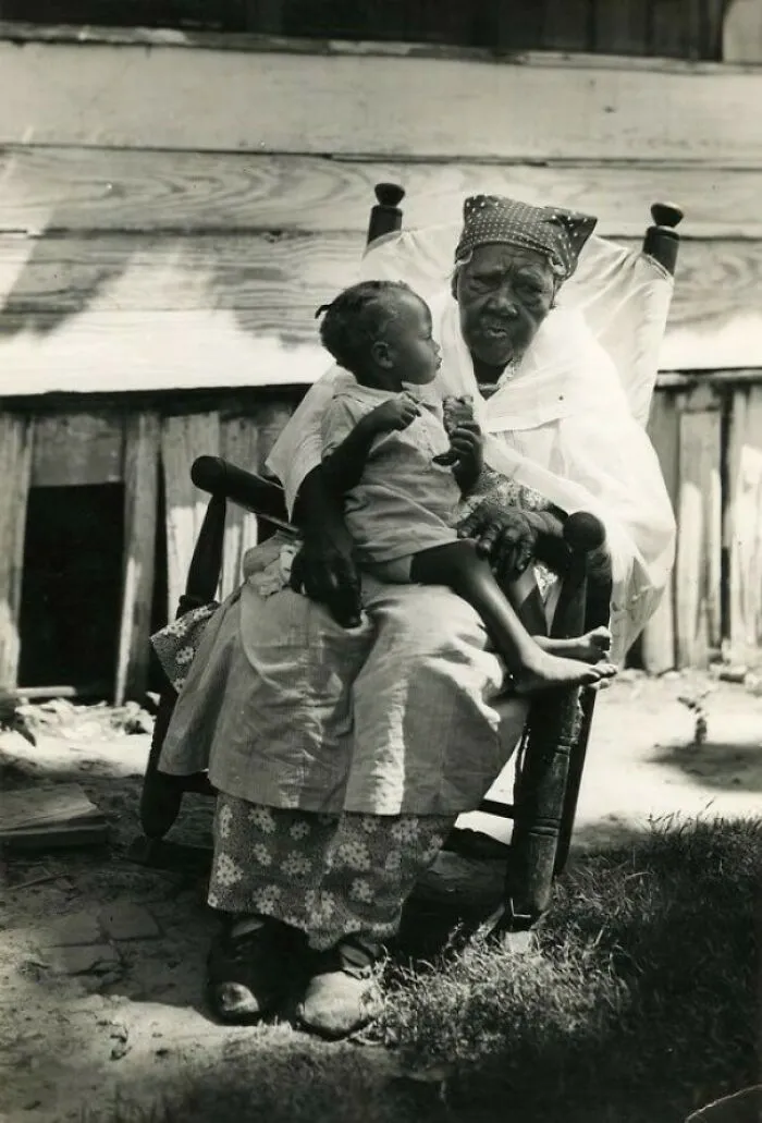 A Little Girl Sits On The Lap Of Her Great-Great Grandmother, Mississippi, C. 1936