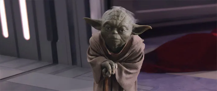 Yoda standing with a walking stick