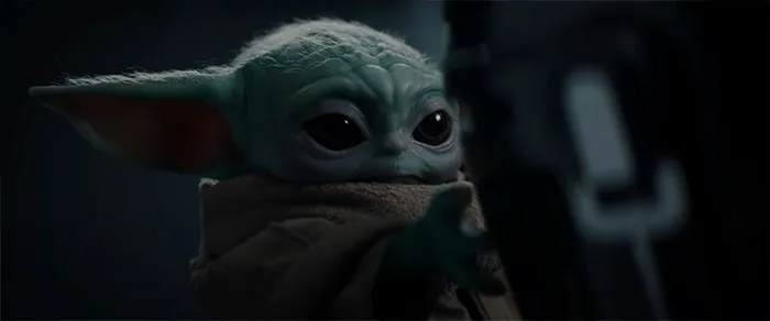 Baby yoda holding his hand forward
