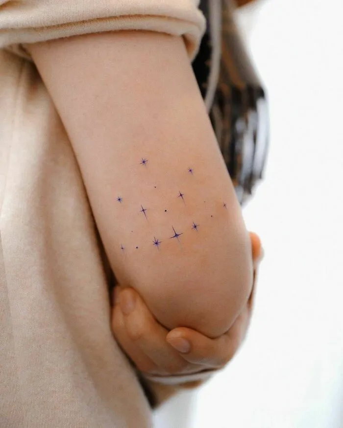 Star Pattern Elbow Tattoo