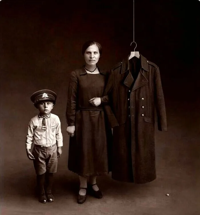 A Memento Mori Photo For A Lost Soldier Husband And Father, 1925. The Boy Wearing His Father’s Uniform Cap And The Wife/Mother Linking Her Arm With His Coat Sleeve Is So Touching