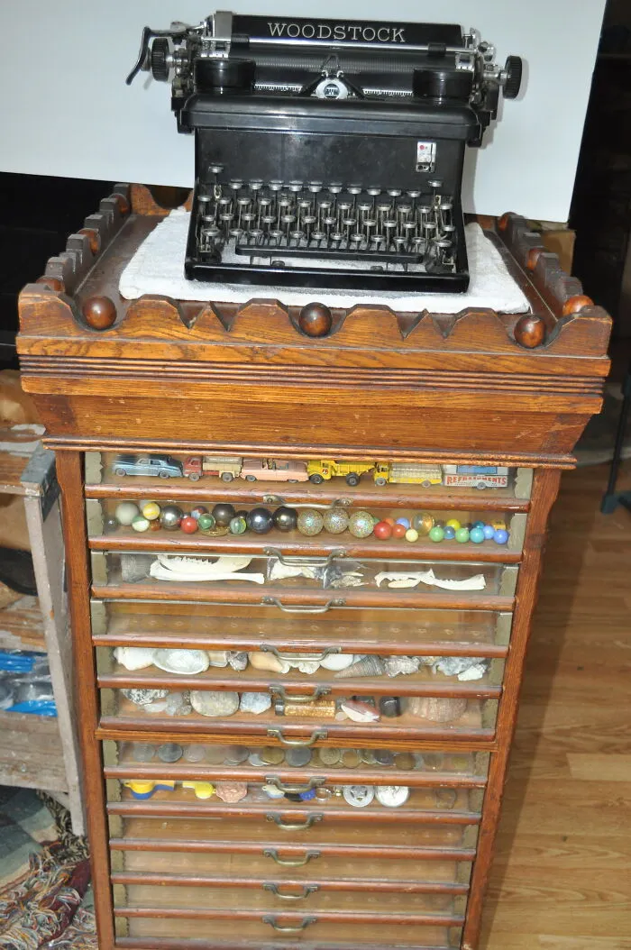 Woodstock Typewriter - 1930s - Belonged To My Grandmother. I Used To Play With It In The 60s.  Antique Sewing Thread Display Case From A Department Store.  Late 1800s. Bonus - Whatever You Can See In The Drawers (Lol). Dinky Toys Cars, Antique Marbles, Bones, Seashells, Foreign Coins, Misc