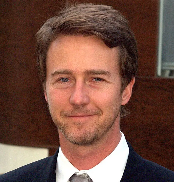 Edward Norton, an actor, smiles at the camera, showcasing his amazing career in film.