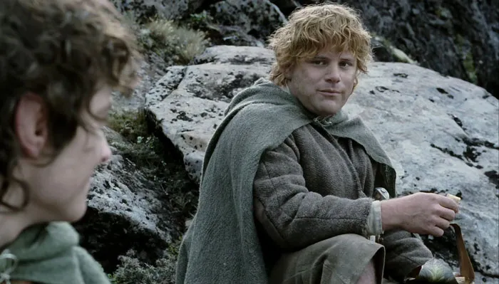 Samwise Gamgee speaking with Frodo in the mountains