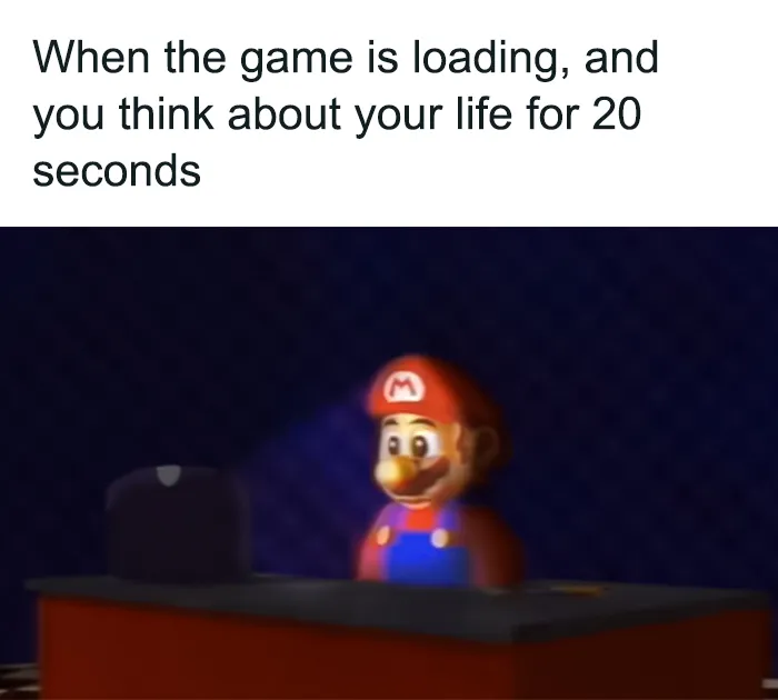 Mario meme with blurred graphics shows Mario sitting at a desk, deep in thought while the game is loading.