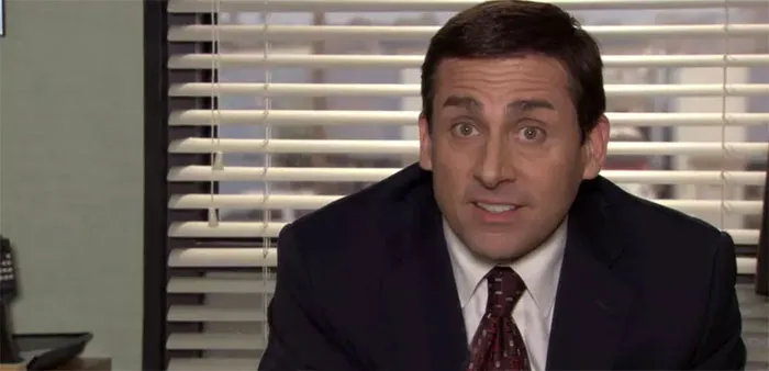Michael Scott talking in a suit and tie, expressing a humorous or serious moment as the best boss ever on The Office.