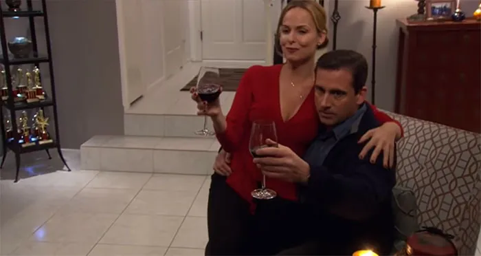 Michael Scott and Jan Levinson drinking wine together, showcasing a memorable moment of the best boss ever.