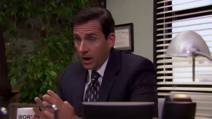 Michael Scott looking nervous at his office desk, showcasing his iconic boss personality from the best boss ever quotes.