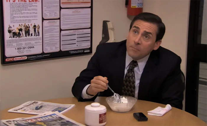 Michael Scott eating ice cream in an office setting, showcasing his quirky personality as the best boss ever.