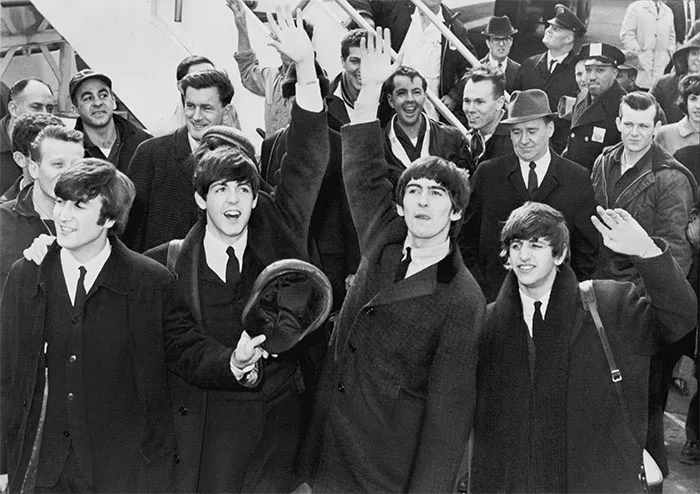 The Fab Four Arrive  
Music History Moment  
Waves and Smiles  
Legends in the Crowd  
Sixties Style Greeting  
Iconic Band Arrival  
Cheers from the Past  
Beatlemania Begins  
Classic Rock Welcome  
Joy in Black and White