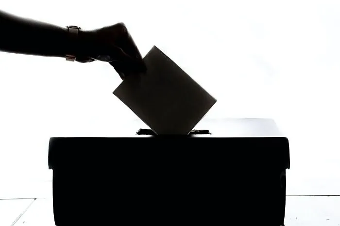 Person Dropping Vote In The Box 