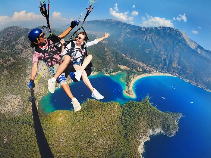 Woman And Man Parachuting 