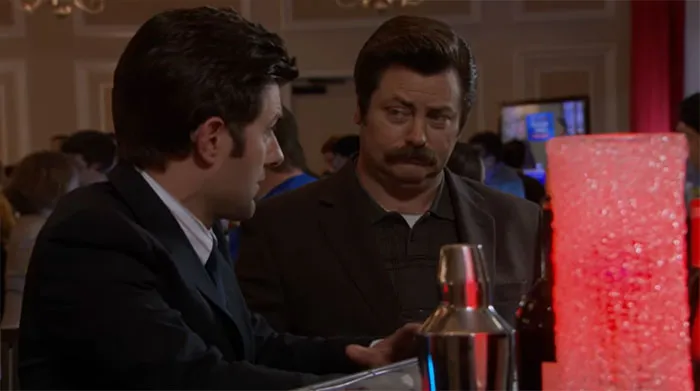 Ron Swanson sharing wisdom with Ben Wyatt at a bar, highlighting memorable Ron Swanson quotes on life.