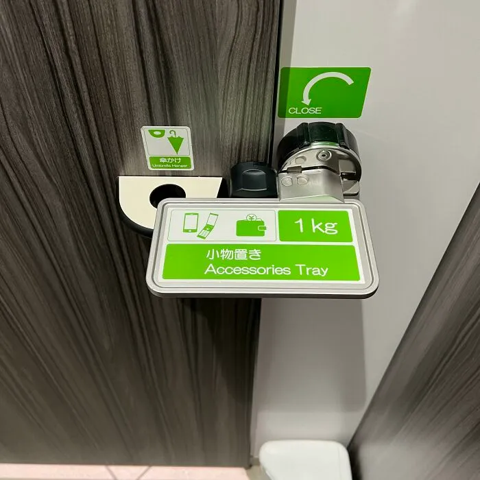 Door Latch That Doubles As An Accessories Holder At A Public Restroom In Japan. Simple Concept, Straightforward Design, Elegant Execution