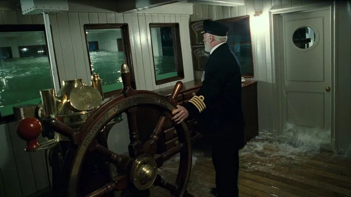 Captain Edward John Smith  standing next to ship's steering wheel when the Titanic sinks in the 'Titanic' (1997) movie