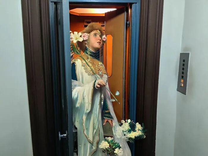An image of a woman from "Lilies" painting in an elevator