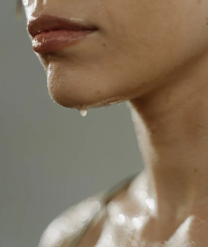 Close up photo of a woman face sweating