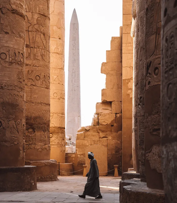 Person Walking Near Columns