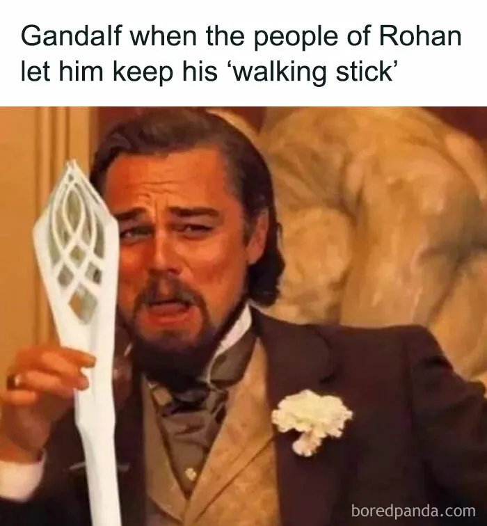 Actor holding a staff with a humorous expression, referencing Middle Earth.