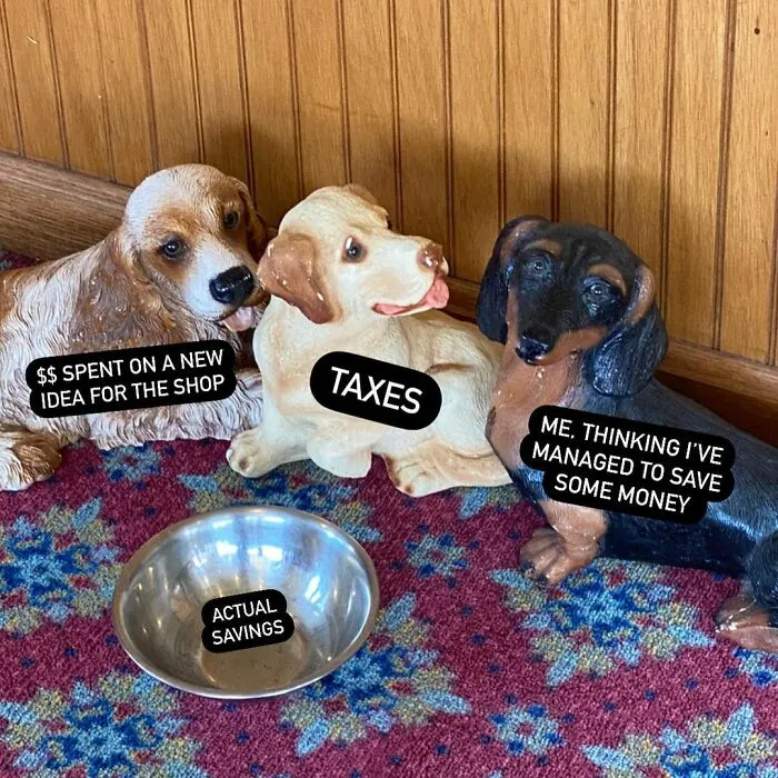 Three dog statues labeled with small biz troubles, humorously depicting spending, taxes, and savings.