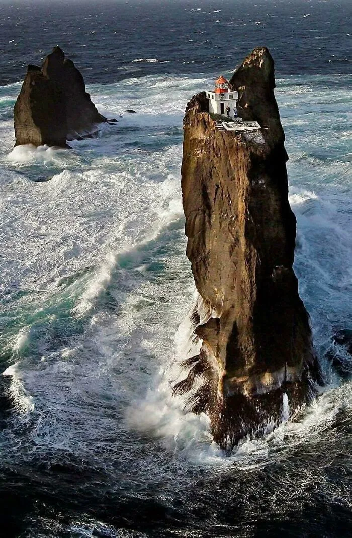 Lighthouse Perched On A Rock Pillar In The Westman Islands, Iceland