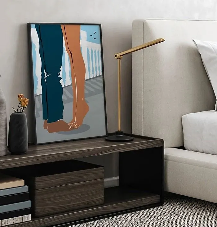 Artwork featuring a couple’s legs on a nightstand beside a modern lamp, showcasing bedroom wall decor ideas.